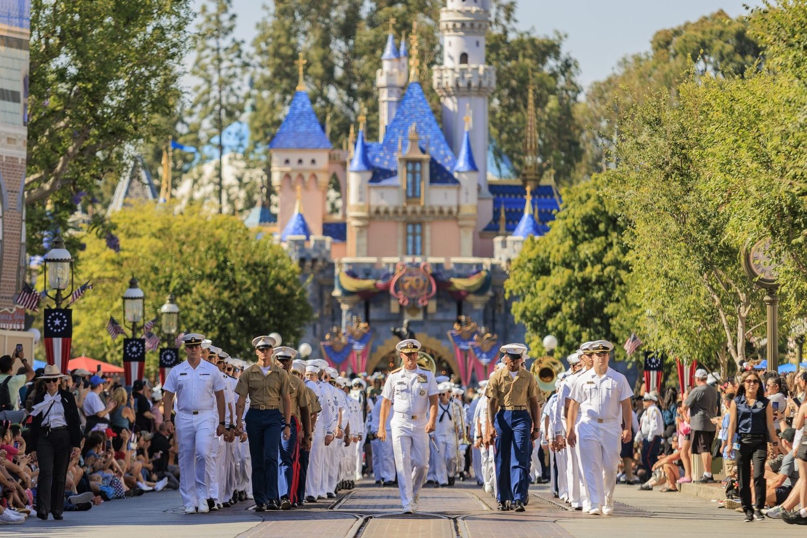 Service members march down Main Street, U.S.A. toward Sleeping Beauty Castle during Disney Celebrates America at the Disneyland Resort (Photo: Disney)