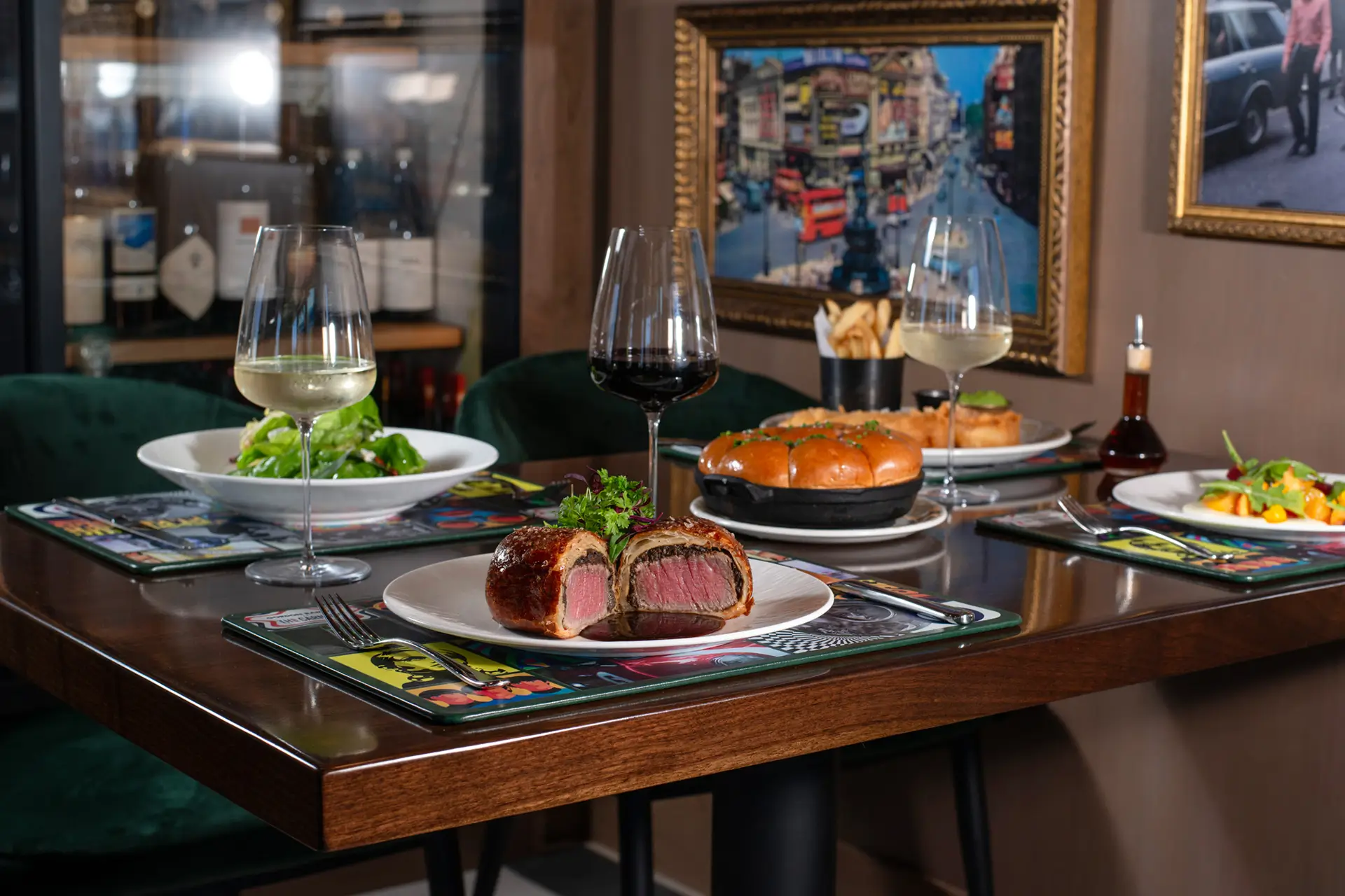 Sliced beef Wellington served with sides on a branded plate at Gordon Ramsay at The Carnaby. | CREDIT: Gordon Ramsay at The Carnaby