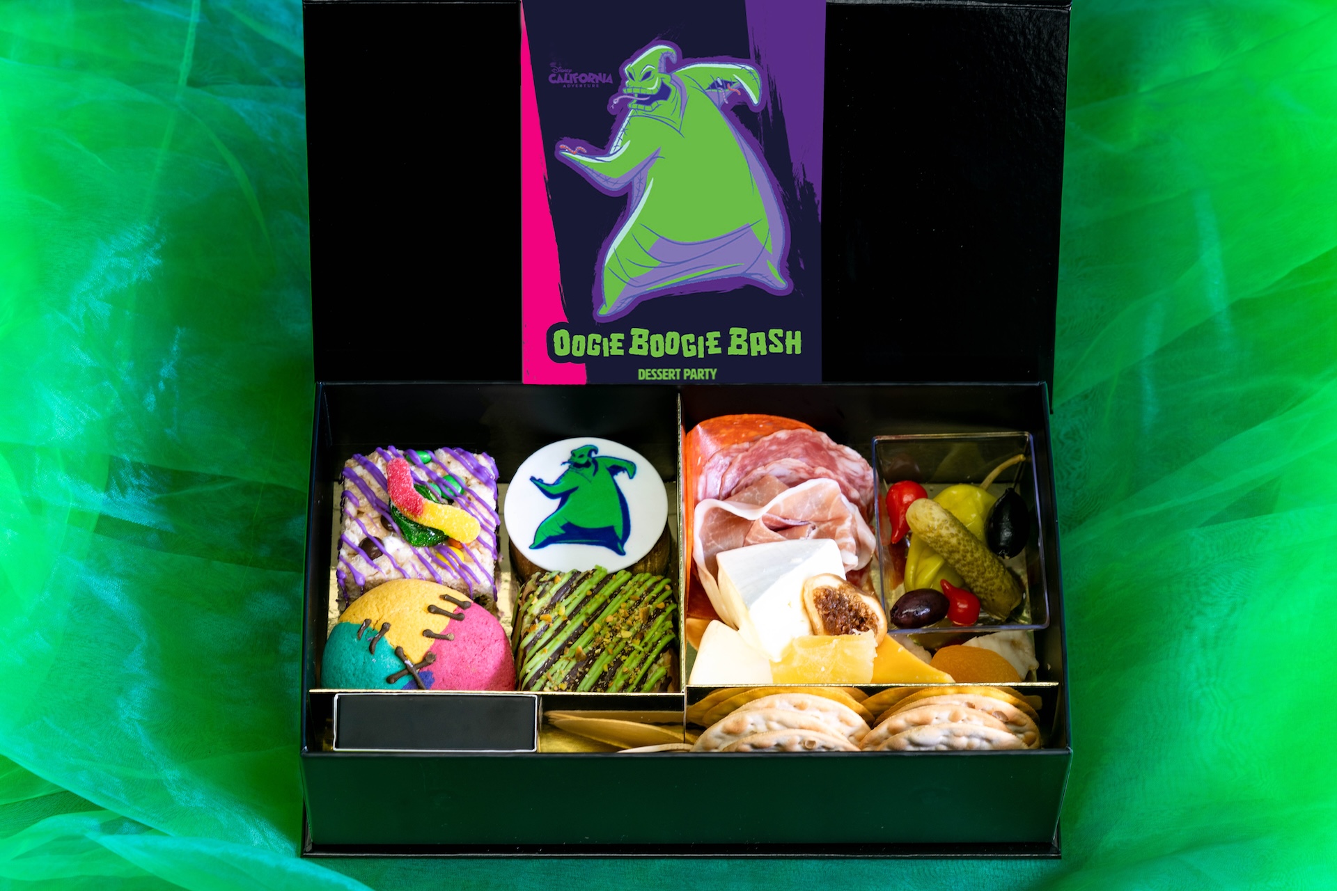 A boxed assortment of desserts and savory bites from the Oogie Boogie Bash Dessert Party. | CREDIT: Disney