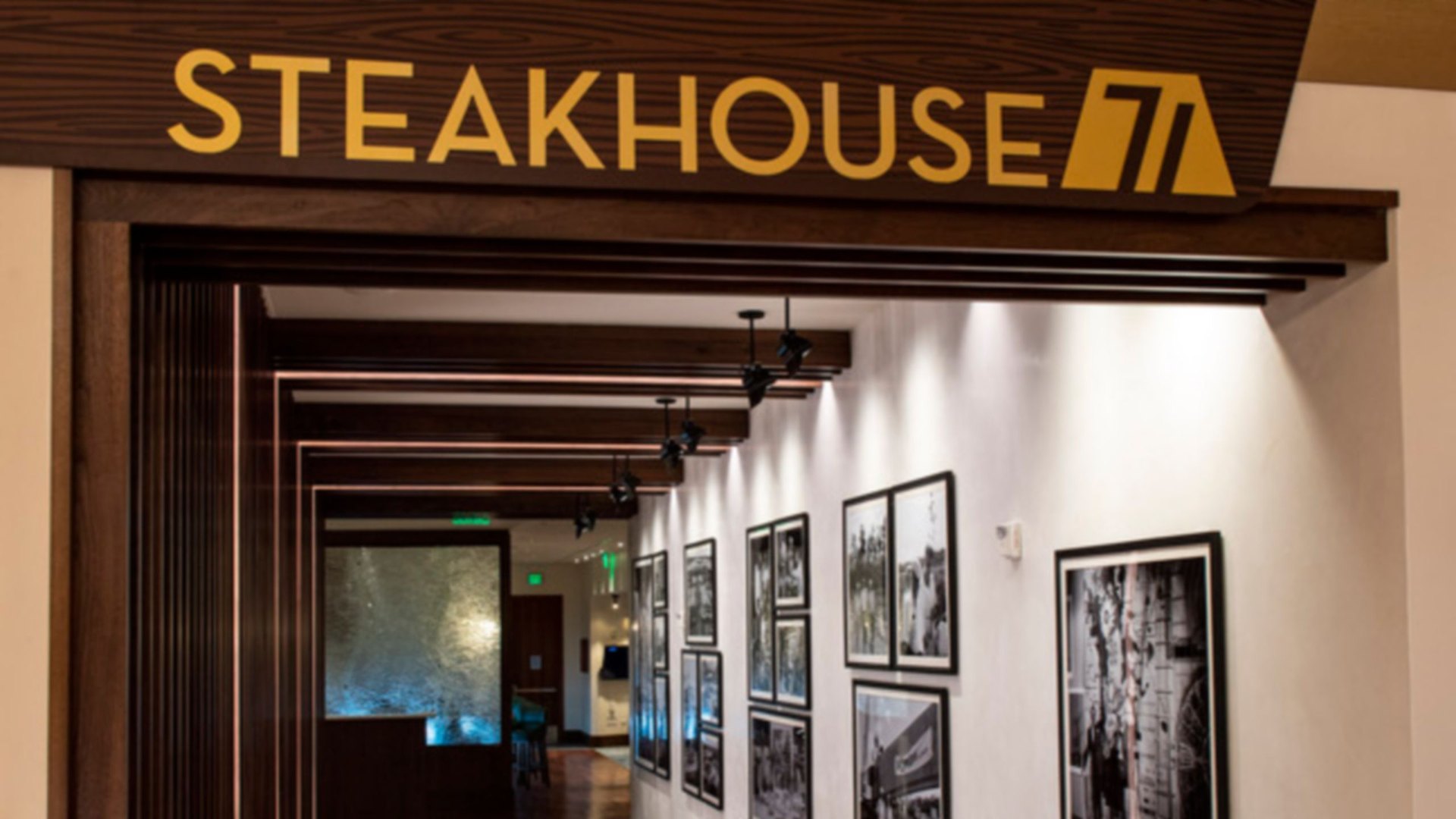 The Steakhouse 71 sign above a hallway lined with framed black-and-white photos Steakhouse 71 at Disney’s Contemporary Resort. Its mobile-order menu, Steakhouse 71 To Go, had 154 listings go up. Photo: Disney