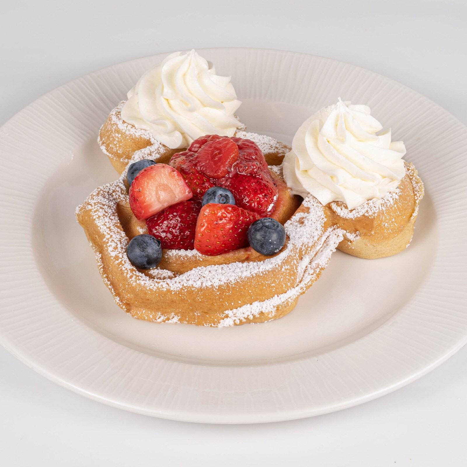 Waffle with Berries, Powdered Sugar, and Whipped Cream